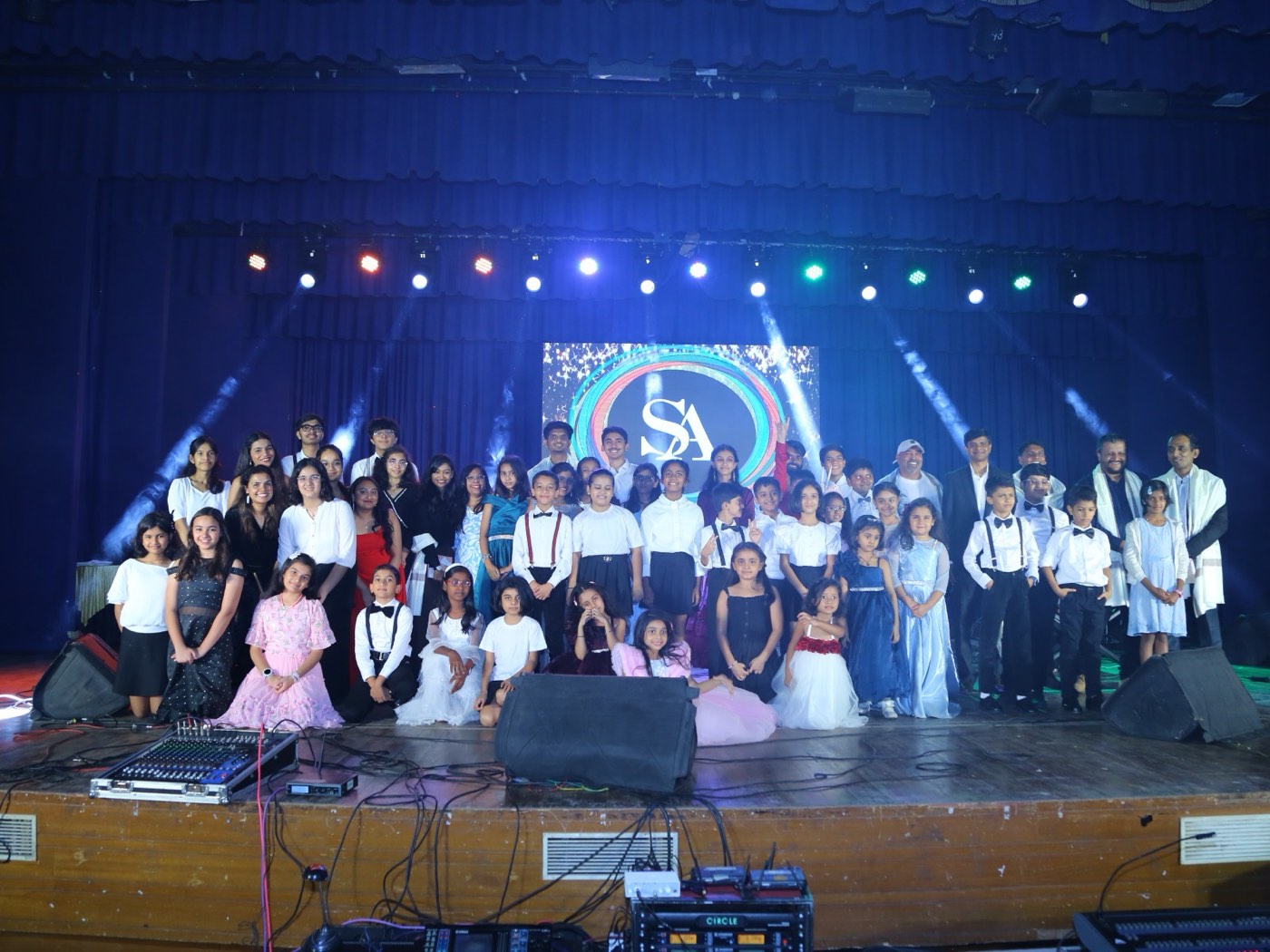 The full cast of performers gathered on stage under the lights