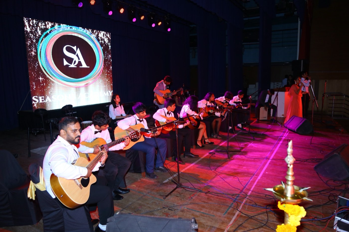 Guitar ensemble of students performing on stage
